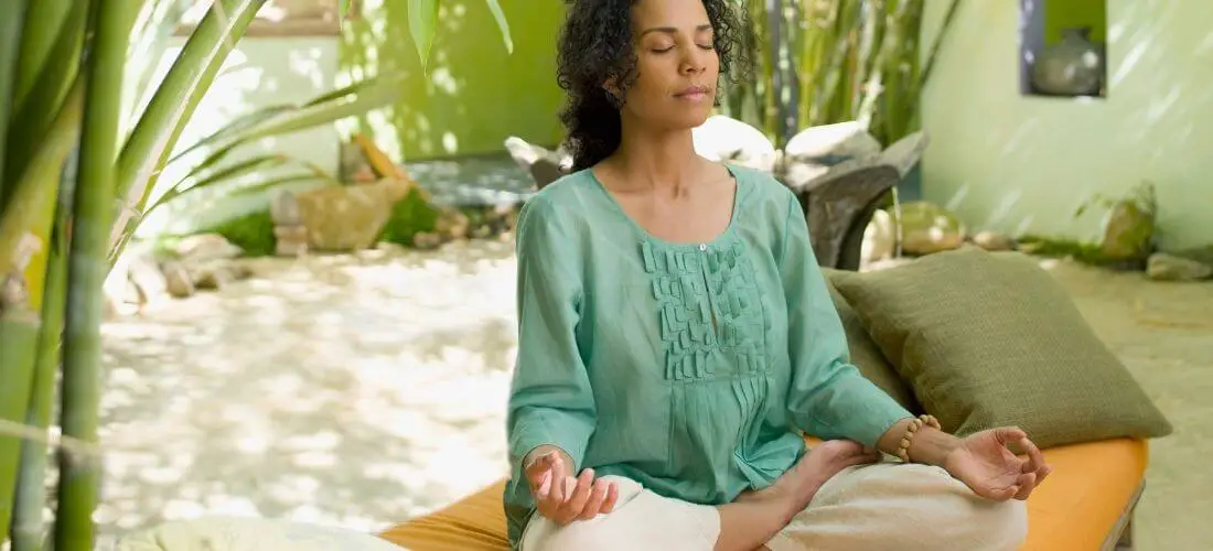 woman meditating outdoors